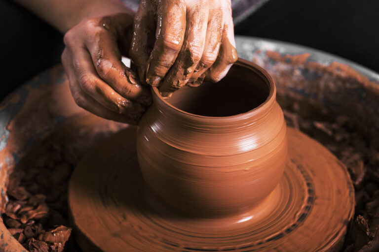 hands of a potter, creating an earthen jar